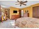 Bright main bedroom featuring neutral carpet, ceiling fan, TV, and ensuite access at 641 Beech W Dr, Plainfield, IN 46168