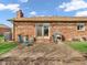 Back patio of a brick home featuring outdoor seating and a grill, ideal for entertaining at 641 Beech W Dr, Plainfield, IN 46168