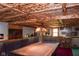 Basement rec room featuring rustic wood ceiling and a pool table with a unique hanging light at 649 E Country Ln, Martinsville, IN 46151