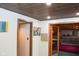 Basement featuring wooden ceiling, signs, and access to pool table room at 649 E Country Ln, Martinsville, IN 46151