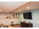 Cozy basement featuring a large mounted TV, shelving and recessed lighting at 649 E Country Ln, Martinsville, IN 46151