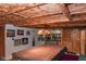 Spacious basement features a pool table, custom wood ceiling, and a rustic sliding barn door at 649 E Country Ln, Martinsville, IN 46151