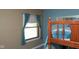 Cozy bedroom featuring a wooden bunk bed next to a window with curtains at 649 E Country Ln, Martinsville, IN 46151