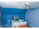 Bedroom with blue walls, sloped ceiling, ceiling fan, and furniture at 649 E Country Ln, Martinsville, IN 46151