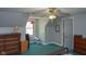 Bedroom featuring a ceiling fan, dresser, window, miniature piano, and doorway to another room at 649 E Country Ln, Martinsville, IN 46151