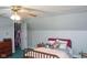 Bedroom includes sloped ceilings, carpet, a closet, and a bed with a pink and gray color scheme at 649 E Country Ln, Martinsville, IN 46151