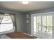 Bedroom boasting a sliding glass door to a balcony, large window, and comfortable neutral bedding at 649 E Country Ln, Martinsville, IN 46151