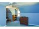 Sloped ceiling bedroom with blue walls, a window, furniture and ceiling fan at 649 E Country Ln, Martinsville, IN 46151