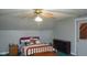 Bedroom includes sloped ceilings, carpet, closet, and a bed with a pink and gray color scheme at 649 E Country Ln, Martinsville, IN 46151