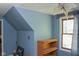 Bedroom with sloped ceiling, window, bookshelf and blue walls at 649 E Country Ln, Martinsville, IN 46151