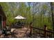 This backyard deck offers a relaxing retreat, featuring an outdoor table and chairs with a wooded view at 649 E Country Ln, Martinsville, IN 46151