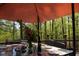 Deck's outdoor table is set for a meal, features floral decor, and offers a view of surrounding woods at 649 E Country Ln, Martinsville, IN 46151