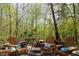 Outdoor fire pit surrounded by mature trees at 649 E Country Ln, Martinsville, IN 46151