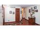 Inviting hallway with hardwood floors, decorative art, and a charming entryway rug at 649 E Country Ln, Martinsville, IN 46151