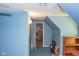 Upstairs hallway with blue walls and view to other rooms at 649 E Country Ln, Martinsville, IN 46151