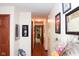 Hallway with wood floor, neutral walls, and decor leading to an inviting living space at 649 E Country Ln, Martinsville, IN 46151