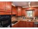 Well-lit kitchen featuring cherry-wood cabinets, granite counters, and stainless steel appliances at 649 E Country Ln, Martinsville, IN 46151
