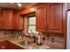 Classic kitchen with granite countertops, cherry-wood cabinets, and stainless steel sink at 649 E Country Ln, Martinsville, IN 46151