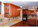 Stylish kitchen with cherry-wood cabinets, granite counters, and modern lighting at 649 E Country Ln, Martinsville, IN 46151