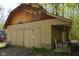 Exterior shot of an outbuilding/barn showing the siding, metal roof, and covered porch with rocking chair at 649 E Country Ln, Martinsville, IN 46151