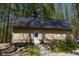 Exterior shot of an outbuilding showing the siding, metal roof, and a garden plot at 649 E Country Ln, Martinsville, IN 46151