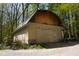 Exterior shot of an outbuilding/barn showing the siding, metal roof and double doors at 649 E Country Ln, Martinsville, IN 46151