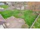 Spacious backyard with green lawn, mature trees and a paved patio area at 66 Coronado Rd, Indianapolis, IN 46234
