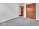Bedroom with gray carpet and wood closet and views to a second door at 66 Coronado Rd, Indianapolis, IN 46234