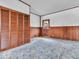 View of paneled bedroom with a large closet and exterior door with decorative window at 66 Coronado Rd, Indianapolis, IN 46234