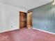 Cozy bedroom features pink carpet and a patterned blue wallpaper accent wall at 66 Coronado Rd, Indianapolis, IN 46234