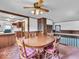 Cozy dining room with wooden furniture, a decorative ceiling fan, and views into the kitchen at 66 Coronado Rd, Indianapolis, IN 46234