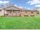 Charming single-story brick home featuring a covered front porch and a well-manicured lawn at 66 Coronado Rd, Indianapolis, IN 46234
