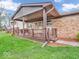 Inviting covered front porch featuring a stylish railing and attractive brick accents at 66 Coronado Rd, Indianapolis, IN 46234