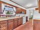 Functional kitchen featuring wood cabinets, and ample counter space with a window view at 66 Coronado Rd, Indianapolis, IN 46234