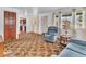Well-lit living room with cozy furniture, large windows, and an open doorway to the kitchen at 66 Coronado Rd, Indianapolis, IN 46234