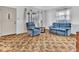 Bright living room with large windows and a comfortable seating arrangement with a blue sofa at 66 Coronado Rd, Indianapolis, IN 46234