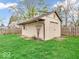 Exterior view of the shed with a white exterior and a green lawn at 66 Coronado Rd, Indianapolis, IN 46234