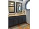 Bathroom with double sink vanity, stone countertop, tiled walls, and octagon window at 7211 Kensington Ct, Avon, IN 46123