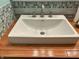 Close-up of a bathroom sink with a sleek faucet and wood countertop, highlighting modern design at 7211 Kensington Ct, Avon, IN 46123