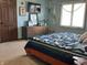 Comfortable bedroom with modern decor, colorful quilt, and natural light from the bright window at 7211 Kensington Ct, Avon, IN 46123
