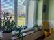 Dining area with plants on windowsill and view of the front yard from a bright sunny window at 7211 Kensington Ct, Avon, IN 46123
