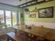 Spacious dining room with unique chandelier, large windows, and rustic wooden table at 7211 Kensington Ct, Avon, IN 46123