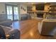 Spacious living room with a fireplace, wood floors, and access to an outdoor patio for relaxing or entertaining at 7211 Kensington Ct, Avon, IN 46123