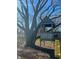 A playhouse with a slide situated beneath a mature tree in the backyard, adding charm and play space at 7211 Kensington Ct, Avon, IN 46123