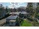 Aerial view of the home featuring a stone patio, mature trees, and lush landscaping at 7525 N Meridian St, Indianapolis, IN 46260