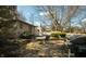 Backyard featuring a stone patio, mature trees, and outdoor seating at 7525 N Meridian St, Indianapolis, IN 46260