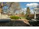 Backyard featuring a stone patio, a hot tub, mature trees, and outdoor seating at 7525 N Meridian St, Indianapolis, IN 46260