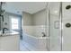 Bright bathroom with a double vanity, soaking tub, and a glass-enclosed shower at 7525 N Meridian St, Indianapolis, IN 46260