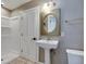 Bathroom boasts a stand alone sink, walk-in shower, and modern fixtures at 7525 N Meridian St, Indianapolis, IN 46260