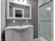 Well-lit bathroom with a stylish vanity, a large mirror, and a glass-enclosed shower at 7525 N Meridian St, Indianapolis, IN 46260